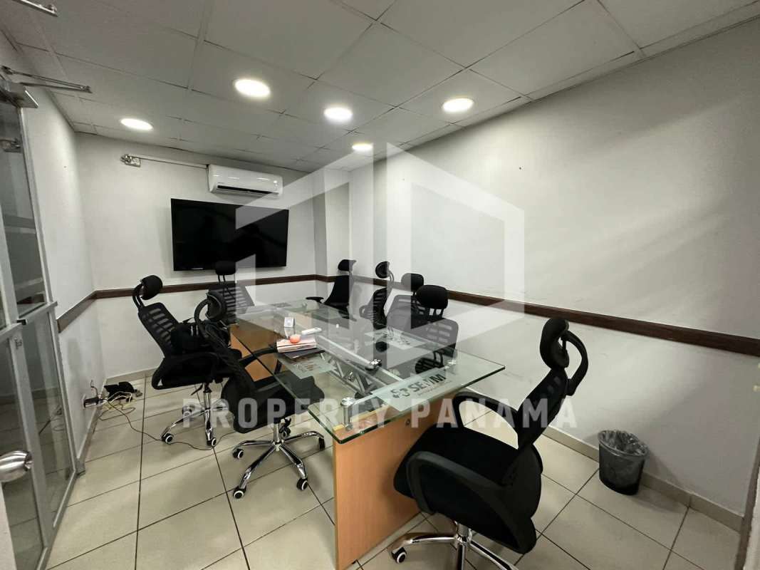 Conference room with glass table, black chairs, AC, LED lighting in commercial property El Ingenio Panama