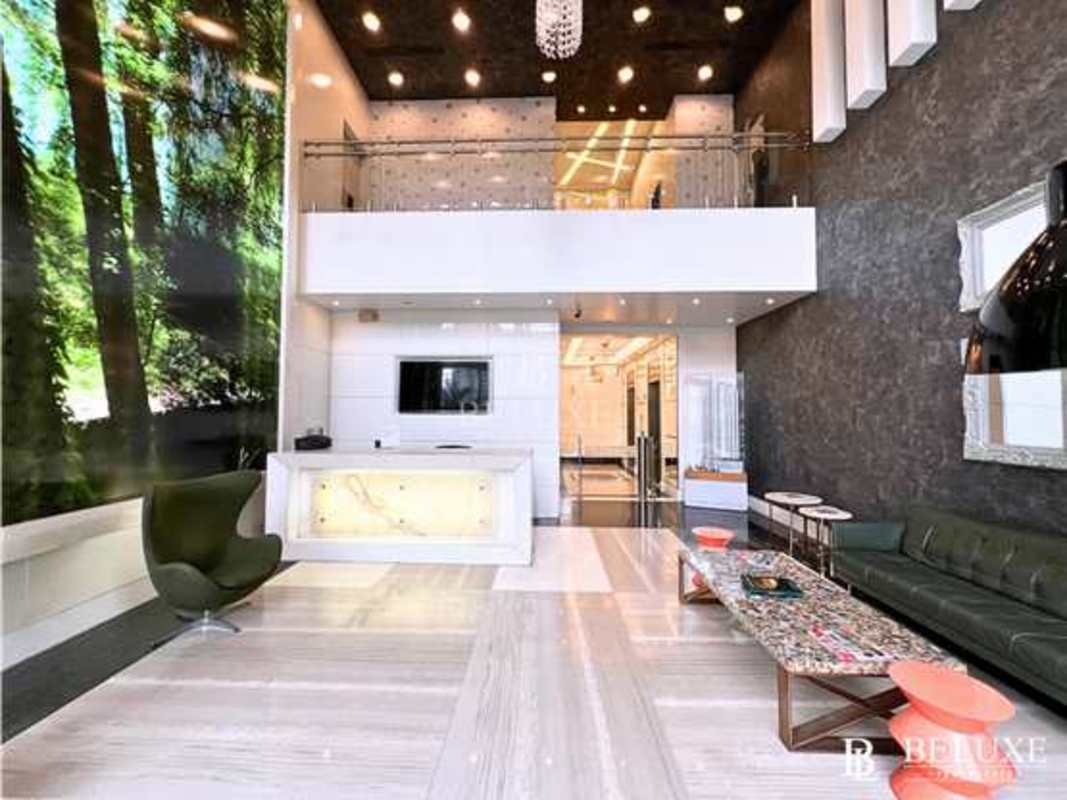 Double height lobby with forest mural mezzanine in Habitats Plaza Bella Vista Panama City