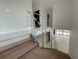 Modern entrance hall with balcony view and staircase in elegant Nativa home Panama Pacifico