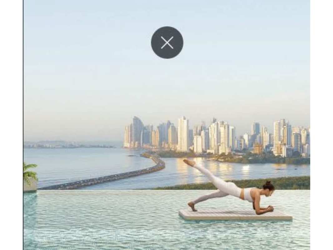 Beachfront pool deck with palm trees and skyline PH Costa del Mar Costa del Este