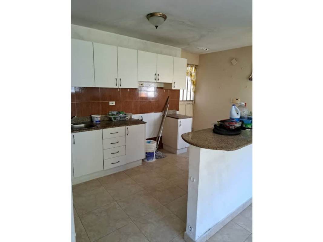 Open kitchen with granite counters, breakfast bar, white cabinets in Condado del Rey Panama