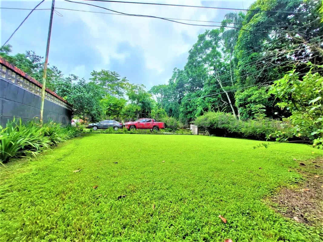 Traditional rustic kitchen with wooden beams, blue tiled floor and island in Las Cumbres house Panama