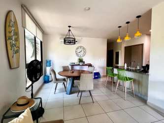 Bright open-plan kitchen with breakfast bar and dining at PH Galeones Playa Ensenada Panama