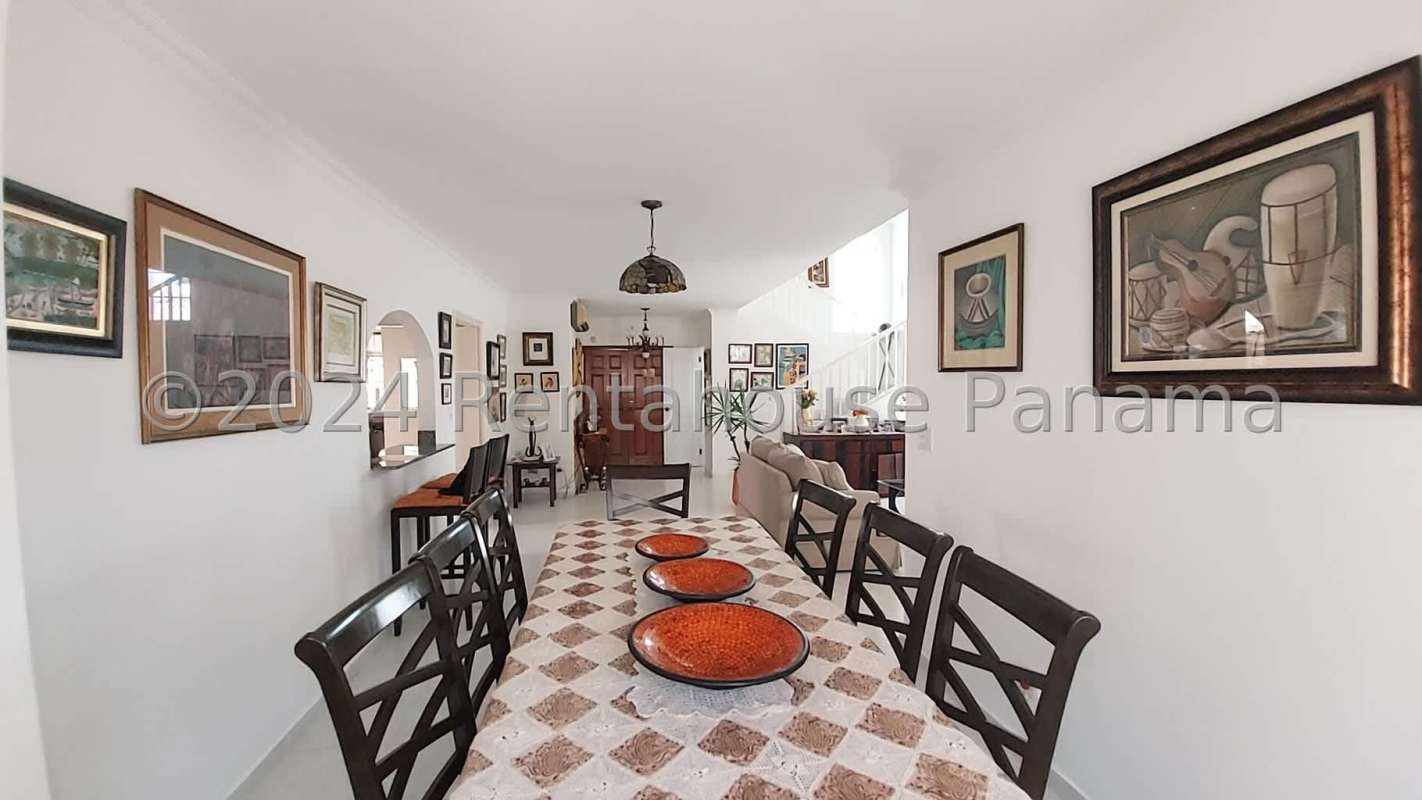 Spacious living room with traditional archway, beige sofas, tile flooring in PH Fuente del Fresno