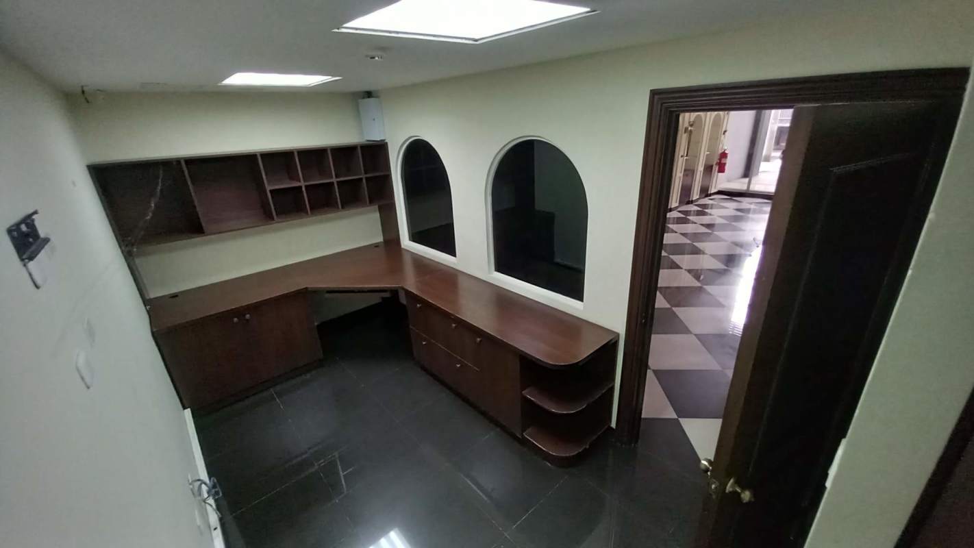 Reception area with L-shaped counter, interior windows and tiled floor for commercial rental in Bella Vista Panama City