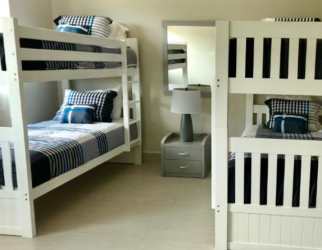 Modern kitchen with granite countertops and cabinet storage Punta Barco Village Panama