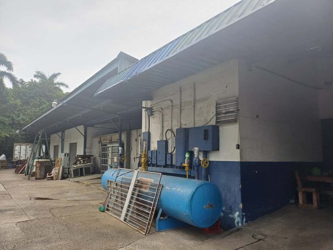 View of industrial cold storage rooms with sliding doors and metal roof at Curundu warehouse Panama City