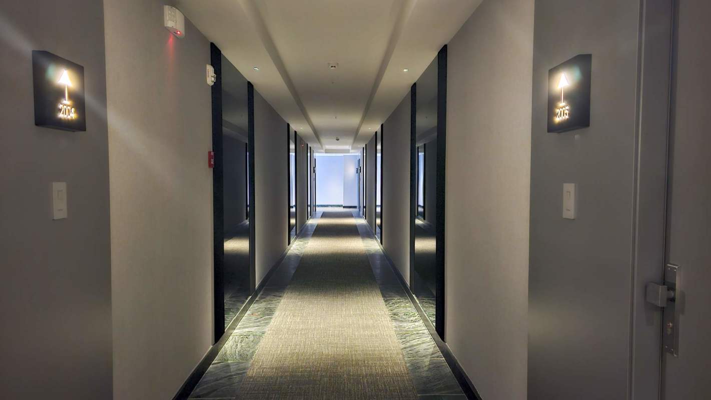 Contemporary dining room with glass table and textured wall in PH Nuovo by Armani Casa Panama City