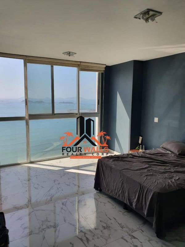 Bedroom with expansive bay view windows marble floors PH Waters on the Bay Panama