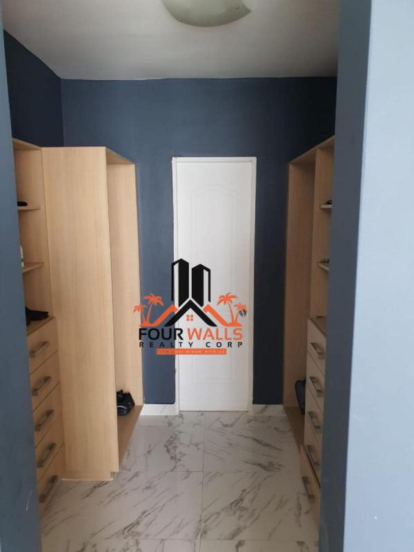 Modern bathroom with marble tiles and glass shower in PH Waters on the Bay