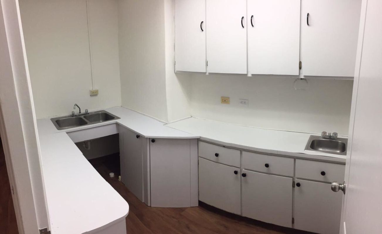 Empty private office with large windows, wood floors and natural light inside Plaza Ejecutiva Obarrio Panama