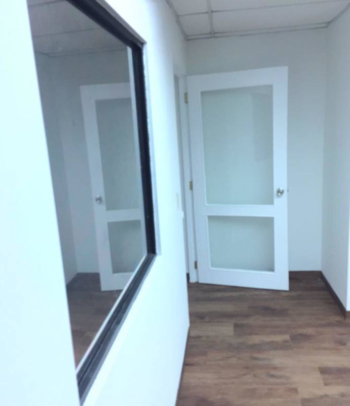 Glass doors with interior window and laminate wood floor office Plaza Ejecutiva