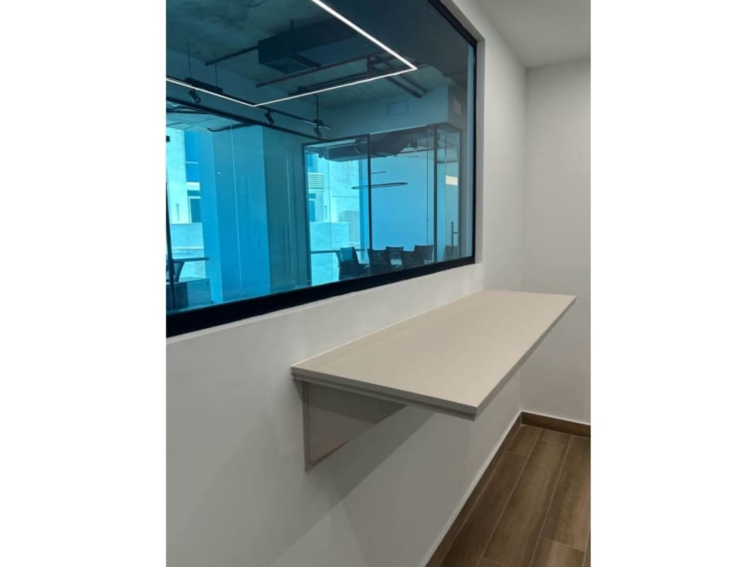 Office corridor with floating desk, large internal window and modern lights in Costa del Este Business Park Tower Panama