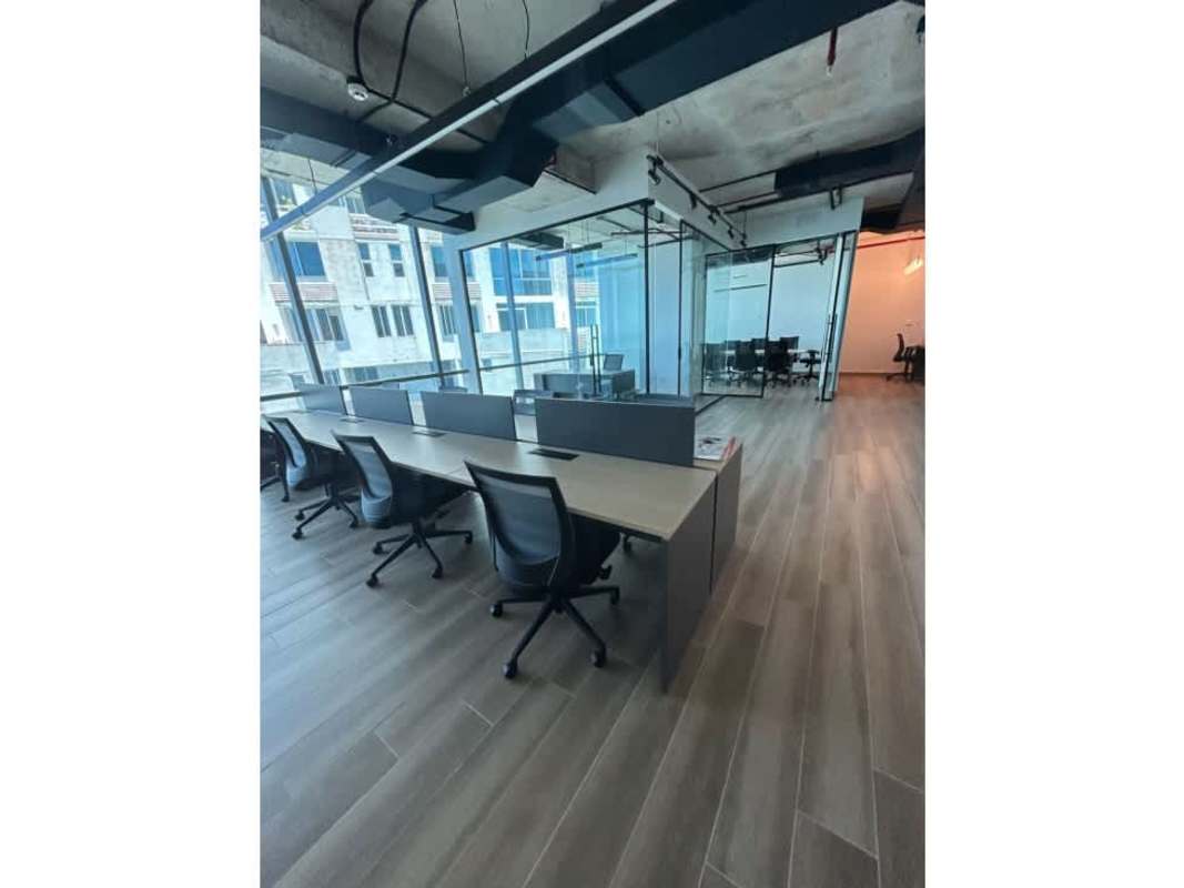 Open-plan workspace with glass partition conference room and large windows in Costa del Este Business Park Tower Panama