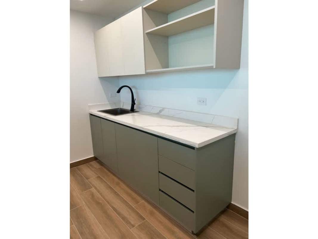Minimalist kitchenette with marble countertop, black faucet and open shelves in Costa del Este Business Park Tower Panama