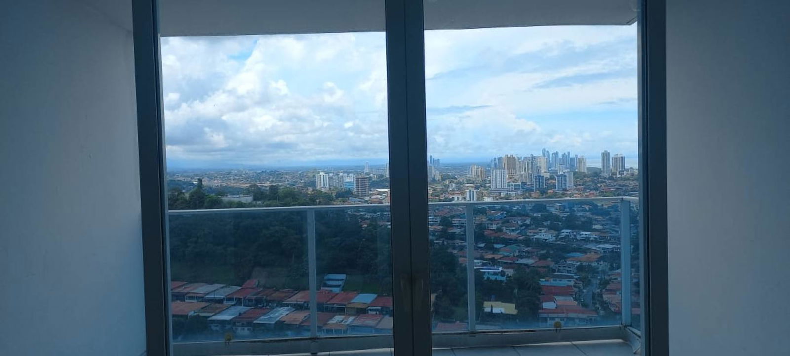 Covered balcony offering panoramic skyline and mountain views in Villa de las Fuentes Panama City