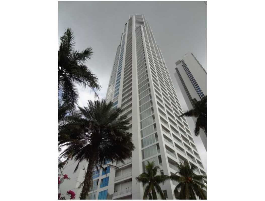 Contemporary skyscraper facade of PH Rivage Tower with palm trees and urban surroundings in Panama City