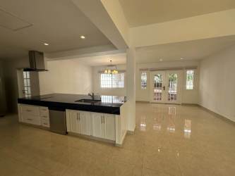 Kitchen island and living area with large windows Howard Panama rental