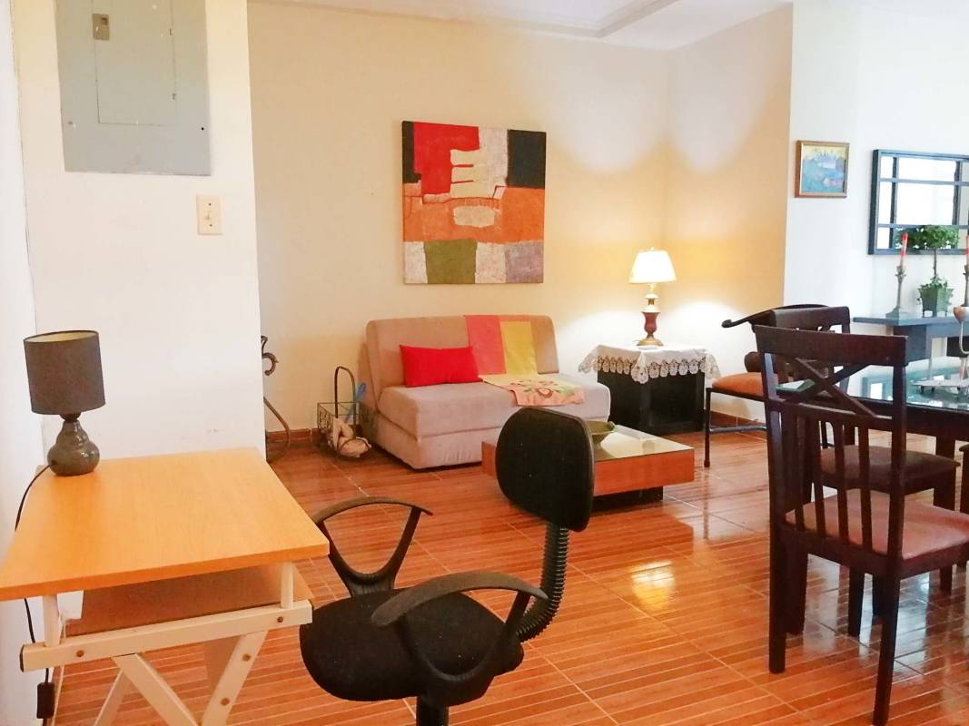 Open living dining room with garden view patio Clayton Village loft apartment