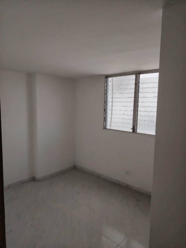 Bedroom with white walls, tiled floors, window bars PH Plaza Madrid apartment Panama City