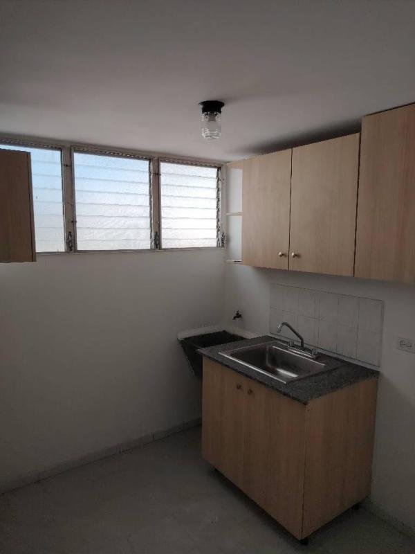 Minimalist kitchen with sink wooden cabinets laundry PH Plaza Madrid Panama City