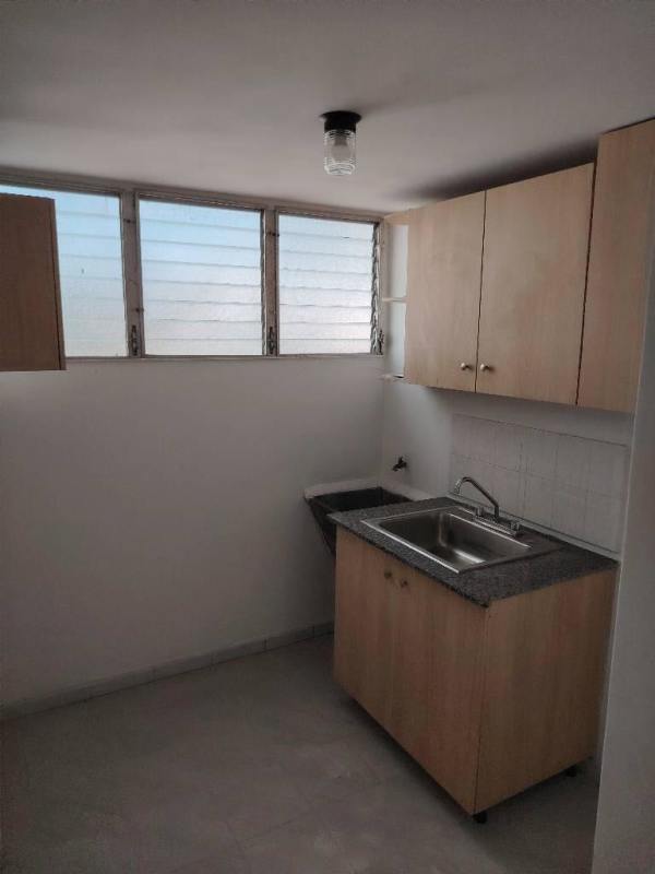 Small kitchen light wood cabinets louvered window PH Plaza Madrid apartment Panama