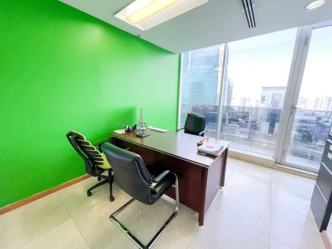 Glass-partitioned meeting room with TV and modern décor in iconic tower Panama City