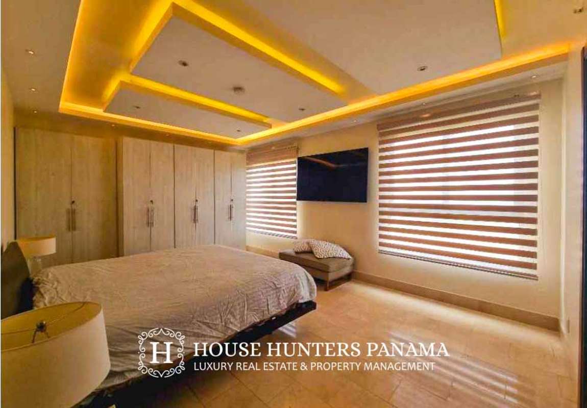 Master bedroom with large window and en-suite bath in Santa Maria Country Club Panama
