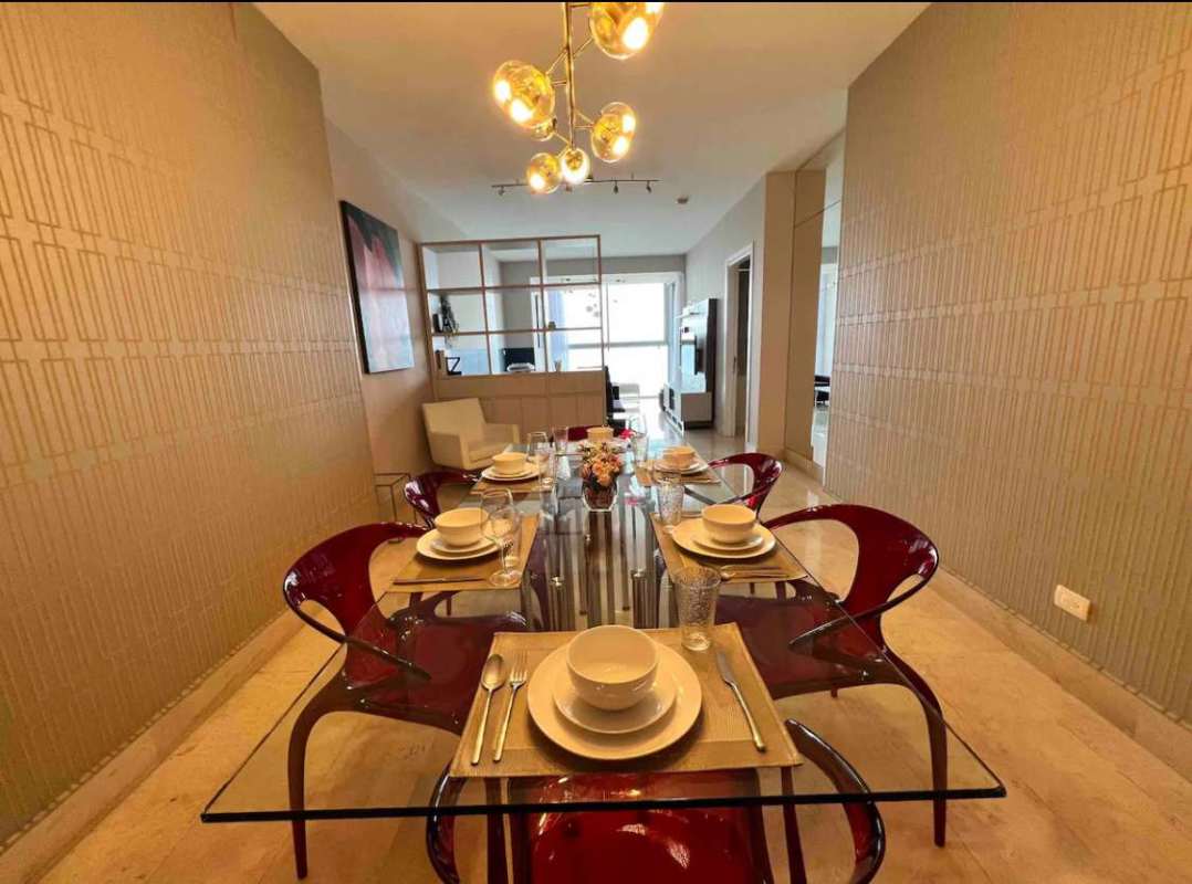 Modern dining area with glass table and designer lighting at Yoo Panama Panama City