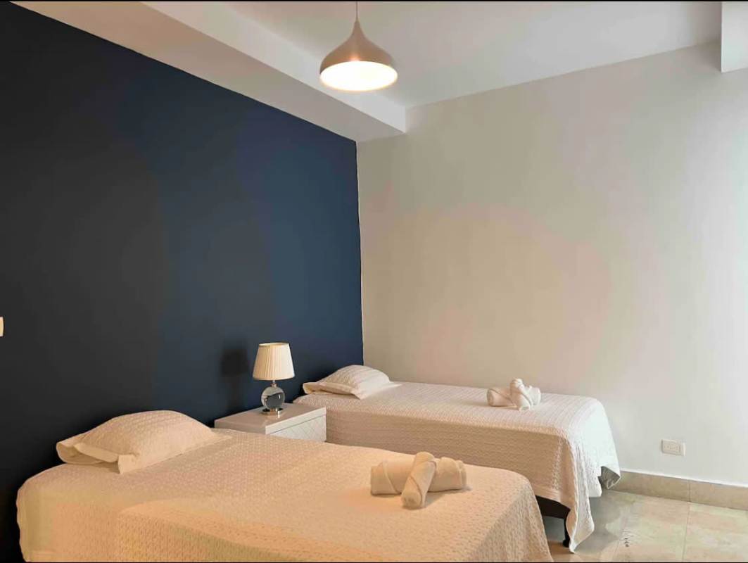 Elegant bathroom with double vanities and glass shower Yoo Panama Panama