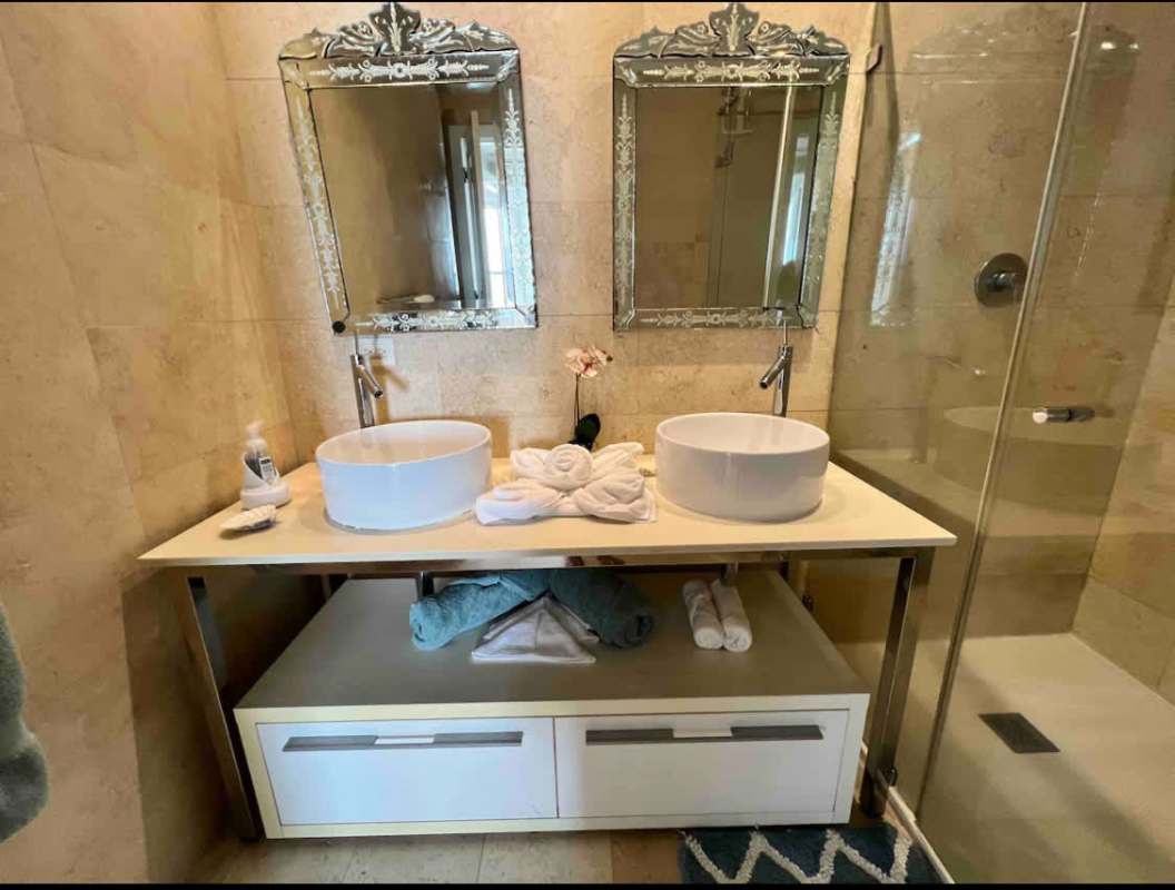 Bathroom with marble tiles glass shower double sinks Yoo Tower Panama