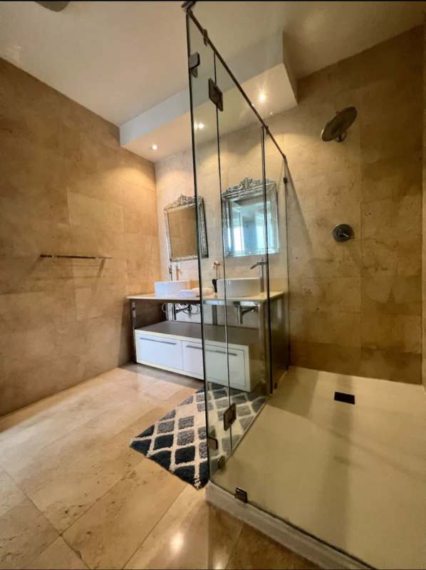 Minimalist twin bedroom with blue accent wall and modern decor at Yoo Panama Panama