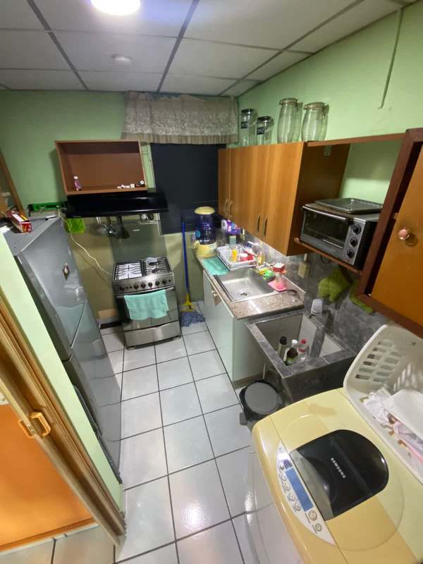 Functional kitchen in budget apartment with appliances cabinets tile floor Rio Abajo
