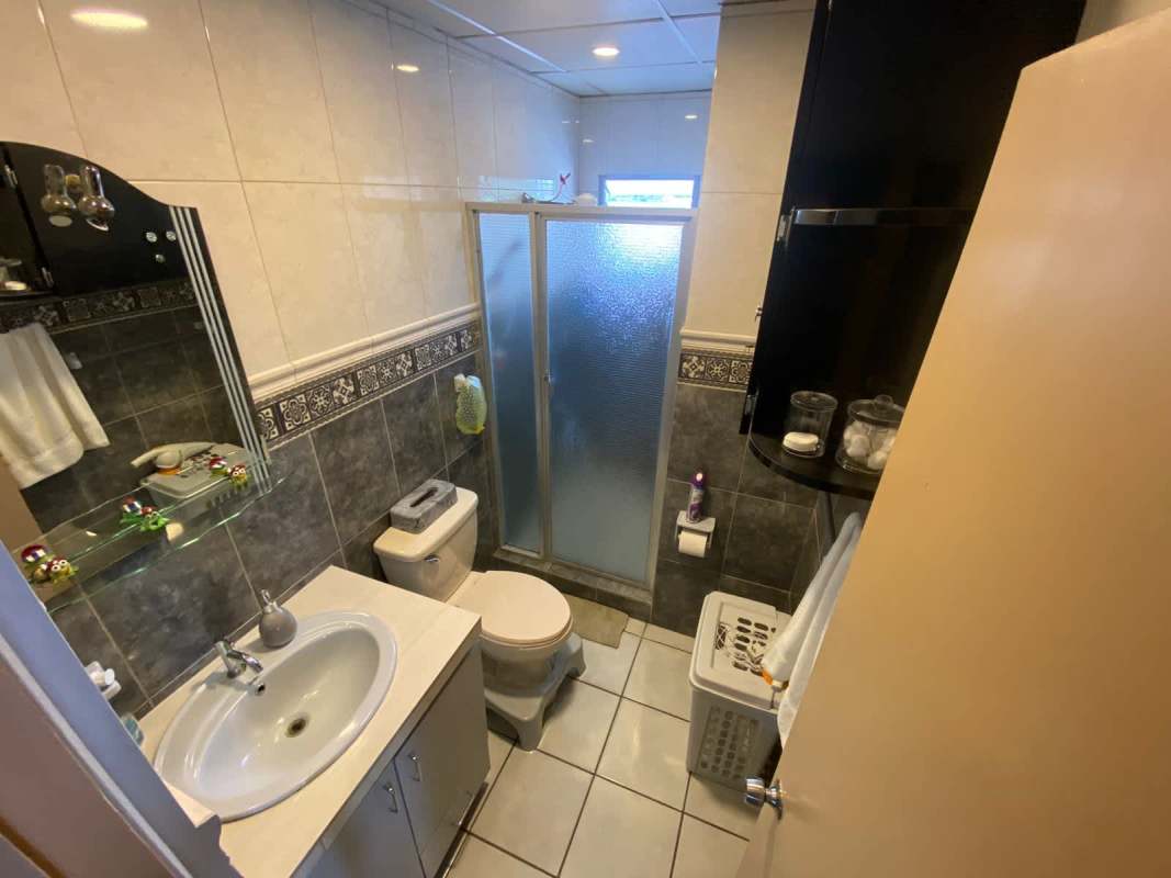 Compact bathroom with shower vanity tile walls affordable PH Plaza Venice apartment