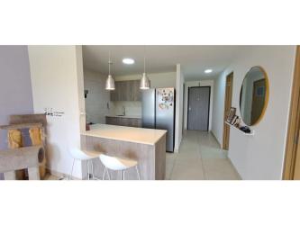 Bright living room with large glass doors opening to balcony PH Parterre Panama Pacifico