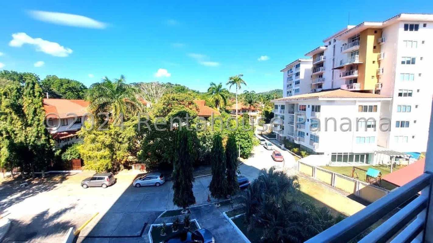 Swimming pool surrounded by tiled deck and palm trees at PH Albrook Point