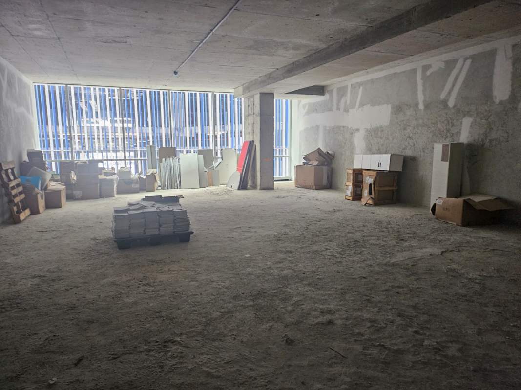 Shell condition open industrial office space with concrete ceiling and windows at PH Arifa Tower Panama