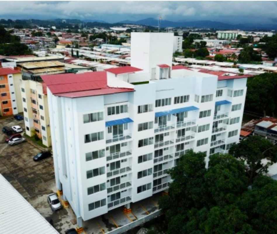 Aerial shot of PH Mystic Gates building with red roof, balconies, and parking, Chanis Panama City