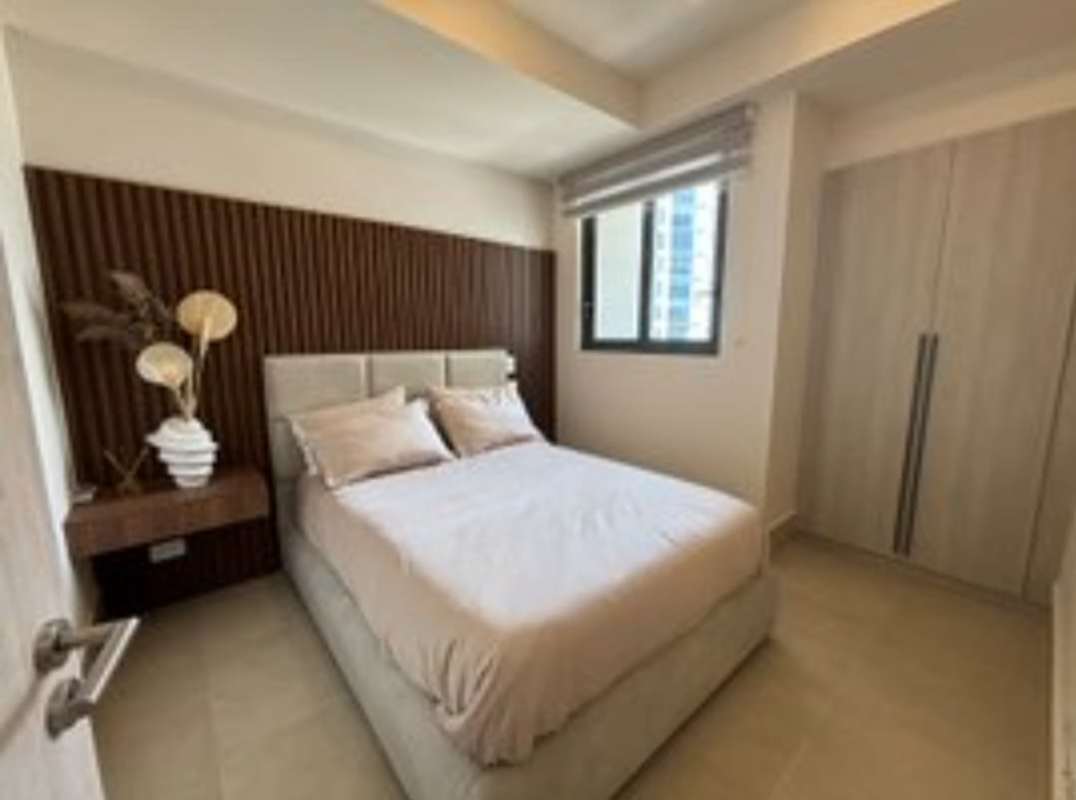 Bedroom with built-in closet, floor-to-ceiling window and city views in Ocean House Santa Maria Panama