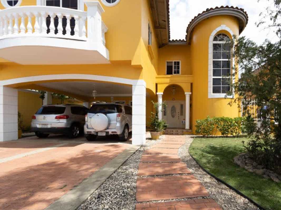 Yellow facade house, turret design, arches, Mediterranean influence PH Rainforest Villas Altos de Panamá