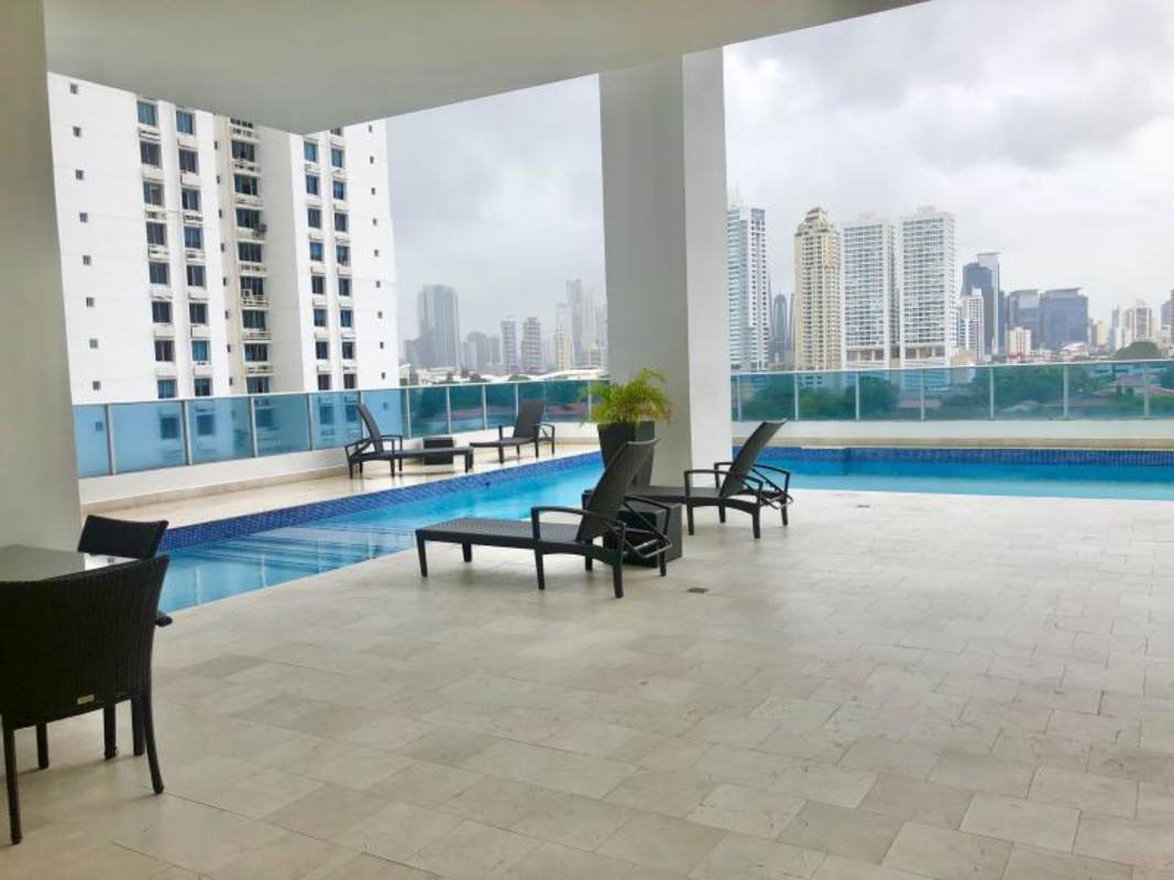 Rooftop covered pool area with lounge chairs at PH Joy Tower Panama City