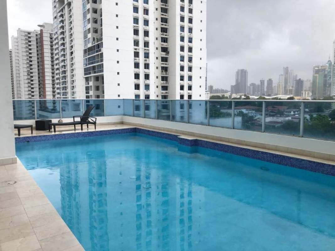 Covered swimming area rooftop with skyline of Panama City at PH Joy Tower