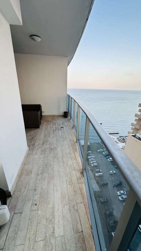 Dining space with floor-to-ceiling windows overlooking skyscrapers at Grand Tower Punta Pacifica