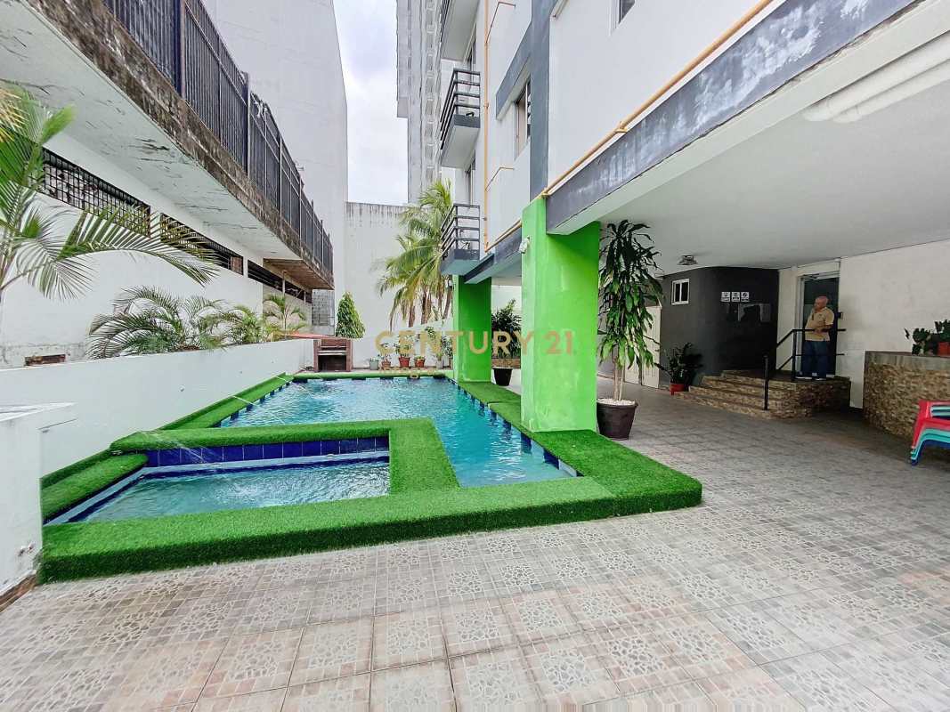 Modern communal swimming pool and Jacuzzi with artificial grass borders in Vista Belle Tower Panama City