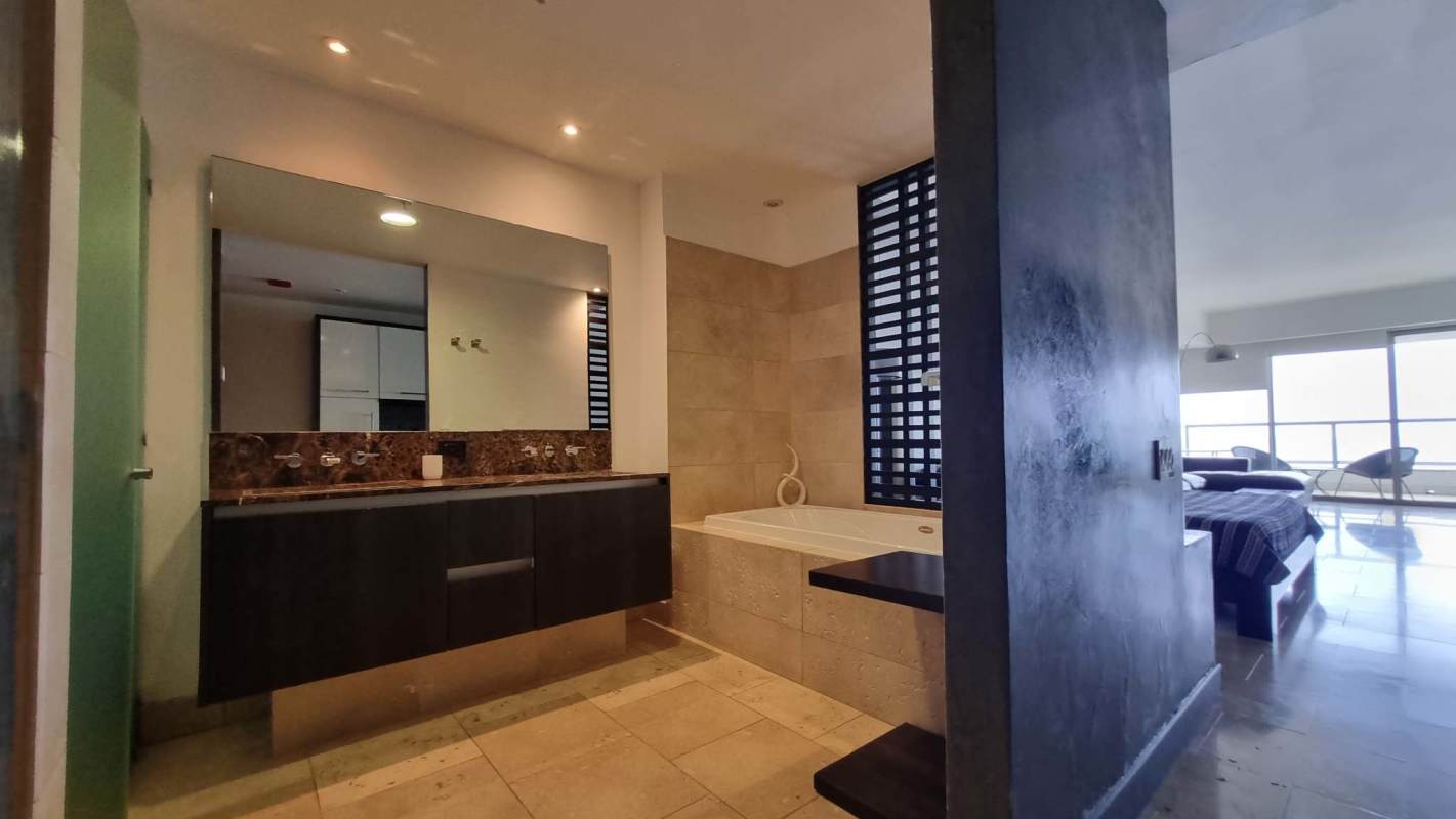 Modern kitchenette with granite countertop and appliances at Trump Tower Condo Panama