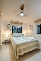 Modern bathroom with double vessel sinks, wood accents and walk-in glass shower Coronado Panama