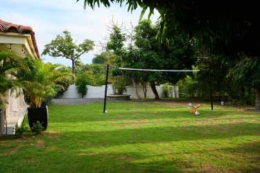 High ceiling open-plan living room and dining area with natural light in luxury Coronado Panama villa
