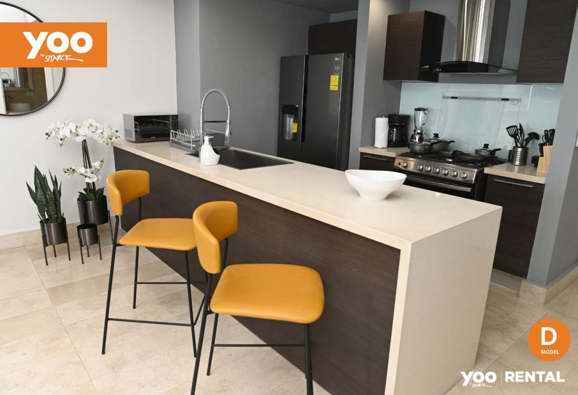 Modern kitchen with quartz countertops island and stainless appliances in PH YOO Panama apartment
