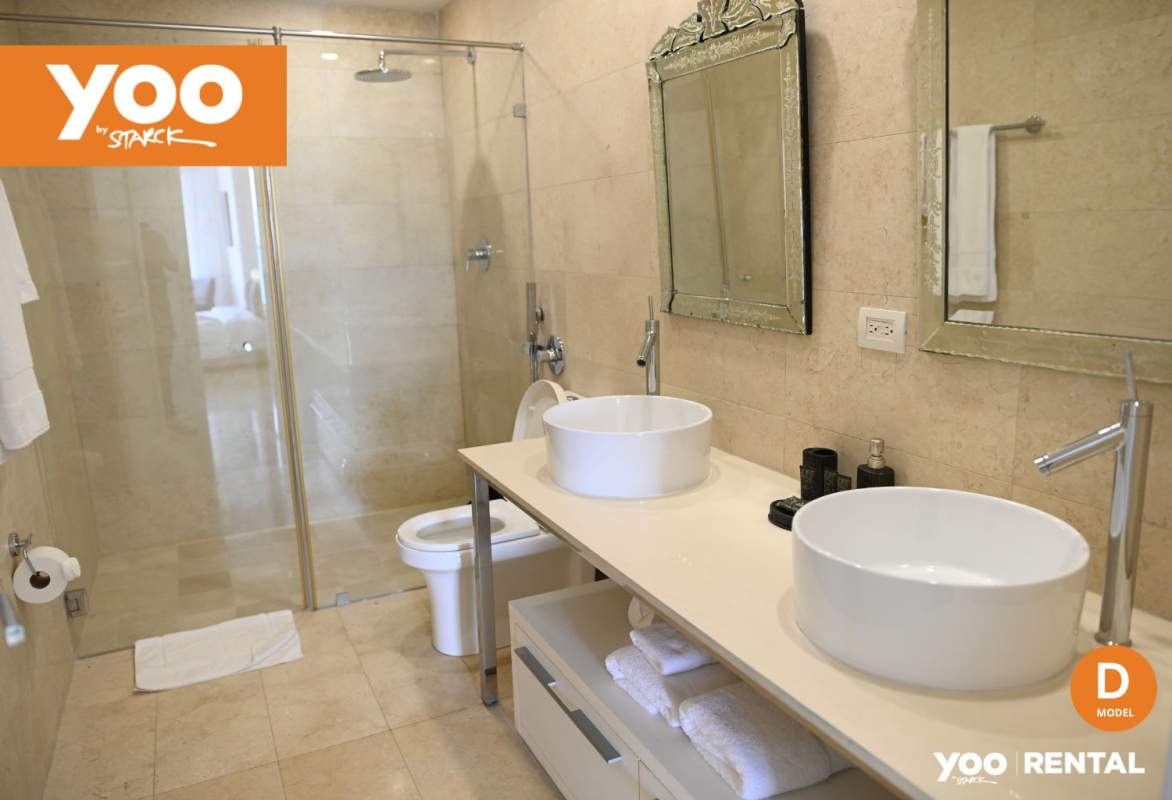 Luxury bathroom featuring dual vanities glass enclosed shower at PH YOO Panama