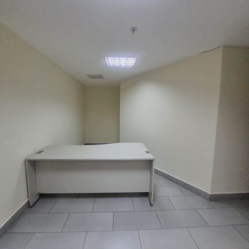 Enclosed private workspace with window and tile floor in Obarrio financial district office